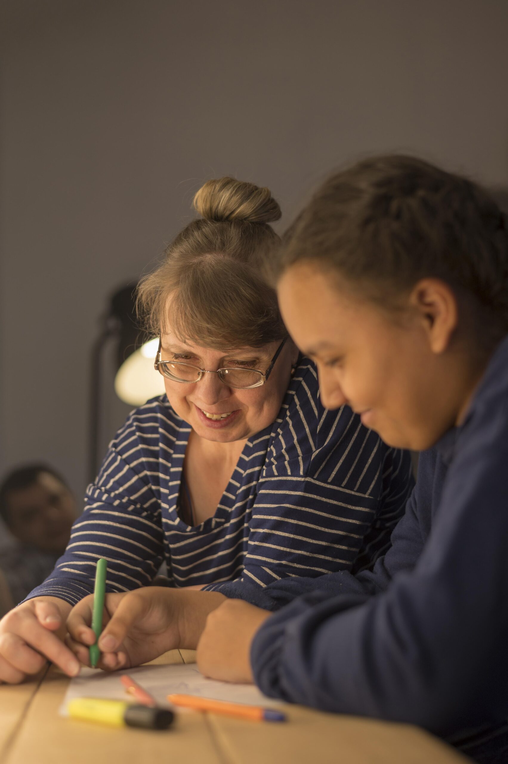 A teacher and student working on some writing together.