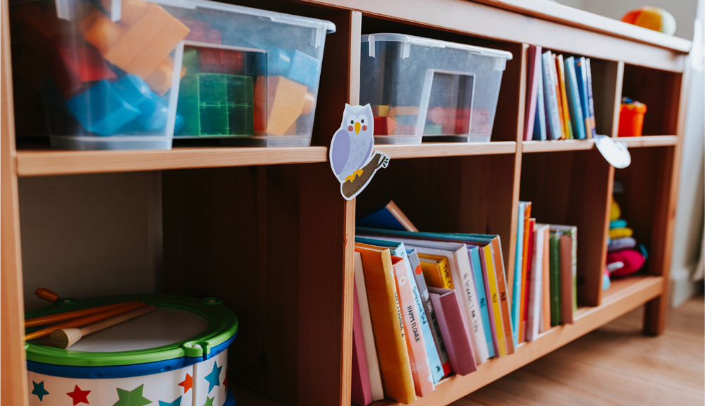 choosing-classroom Image: A bookshelf with toys and children's books.
