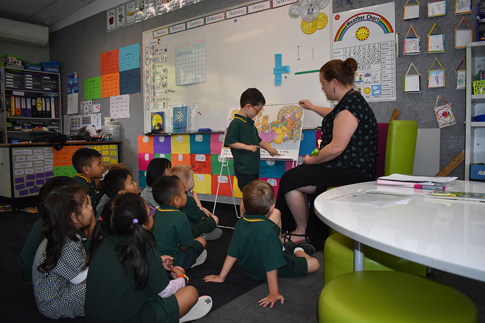 Students and teachers enjoying a picture book and exploring vocabulary together.