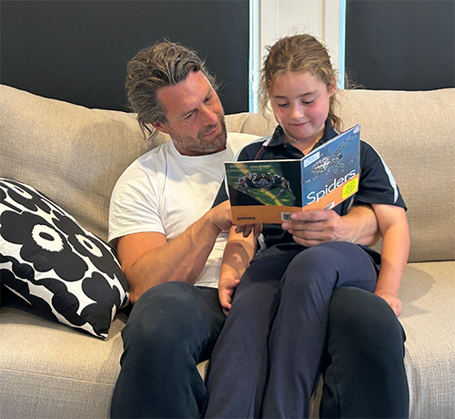 Image: Father and Daughter reading together