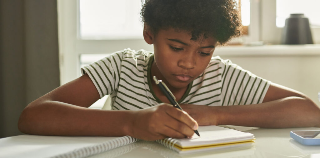 A child writing in a notebook